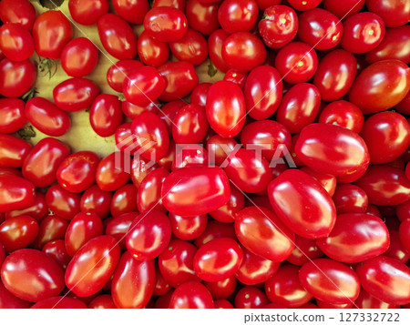 Vivid red cherry tomatoes are showcased in abundance at a bustling market in Spain, inviting shoppers to enjoy fresh flavors and vibrant colors of local produce. Vivid red cherry tomatoes are showcased in abundance at a bustling market in Spain, inviting shoppers to enjoy fresh flavors and vibrant colors of local produce. 127332722