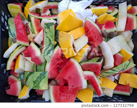 Ripe fruits are being sampled at a market in Denia, Spain, alongside a basket filled with colorful watermelon and melon skins, showcasing local produce. Ripe fruits are being sampled at a market in Denia, Spain, alongside a basket filled with colorful watermelon and melon skins, showcasing local produce. 127332799