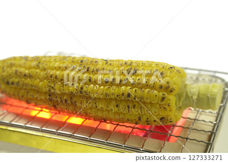 Grilling corn on a charcoal grill 127333271