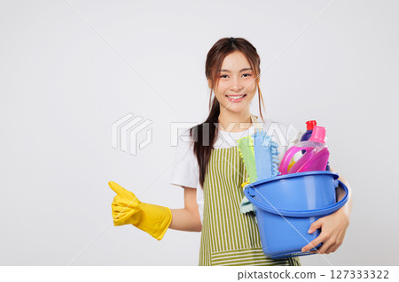 Cleaning expert smile woman in gloves shows thumbs up, holding a bucket with cleaning products. Positive happy cleaning service presentation. isolated studio white background Cleaning expert smile woman in gloves shows thumbs up, holding a bucket with cleaning products. Positive happy cleaning service presentation. isolated studio white background 127333322