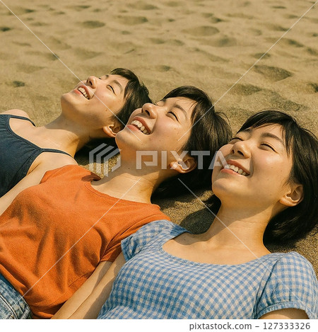 Creating a relaxing scene of three people lying on the beach and looking up at the sky 127333326
