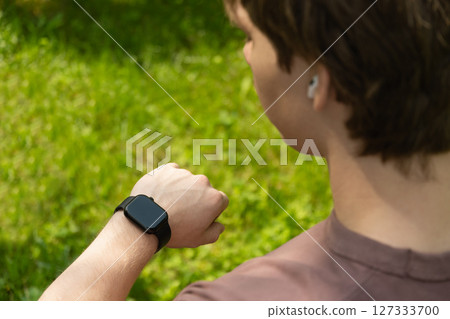 Man hands check apps with smartwatch. Smart watch, nature or hands of athlete for sports workout, heartbeat info or fitness progress on app. Monitor gym data on clock 127333700