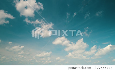 Time lapse. A Serene Blue Sky is best accompanied by Fluffy White Clouds floating peacefully above Time lapse. A Serene Blue Sky is best accompanied by Fluffy White Clouds floating peacefully above 127333748