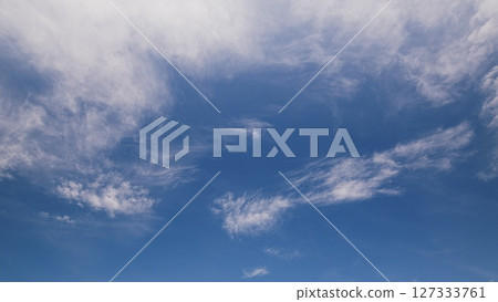 Time lapse. A Serene Blue Sky adorned with Wispy Clouds, Ideal for Capturing Beautiful Nature Scenes 127333761