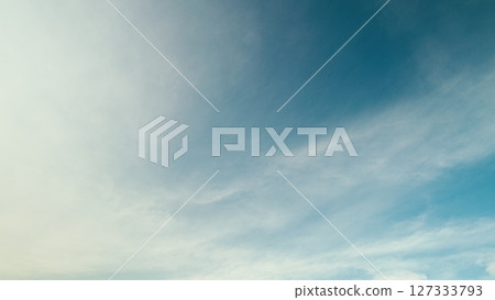 Time lapse. A Beautiful and Expansive Blue Sky Gracefully Decorated with Soft, Fluffy, Wispy Clouds 127333793