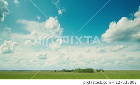 Time lapse. A Serene and Beautiful Landscape Featuring a Clear Blue Sky Accompanied by Cloud Patterns 127333802
