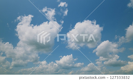 Time lapse. Beautiful Fluffy Clouds Floating in a Clear Bright Blue Sky on a Lovely Afternoon Time lapse. Beautiful Fluffy Clouds Floating in a Clear Bright Blue Sky on a Lovely Afternoon 127333832