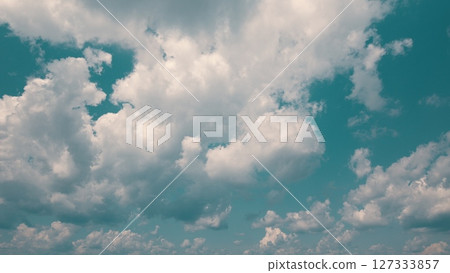 Time lapse. The beautiful skies have fluffy white clouds against a vibrant turquoise background Time lapse. The beautiful skies have fluffy white clouds against a vibrant turquoise background 127333857