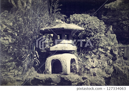 Traditional lantern made of stone in Japanese garden. Black and white photography Traditional lantern made of stone in Japanese garden. Black and white photography 127334063