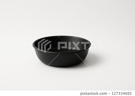 A simple black washbasin placed on a white background 127334085