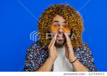 Caucasian young man whisper news rumors holding hands near mouth share gossip quiet keep my secrets 127334413