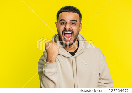 Happy Indian man celebrating success, winning, birthday, lottery jackpot goal achievement, good news Happy Indian man celebrating success, winning, birthday, lottery jackpot goal achievement, good news 127334672
