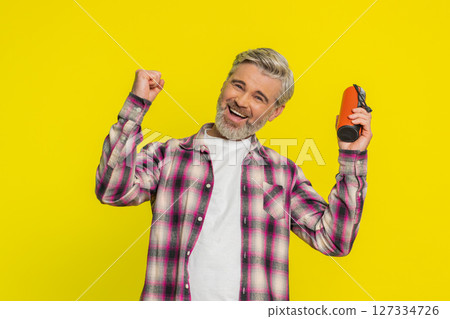 Happy man dancing with portable speaker, joyful freedom, musical expression groove, listening music 127334726