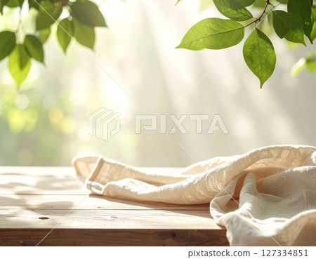 Wooden table and linen with natural light 127334851