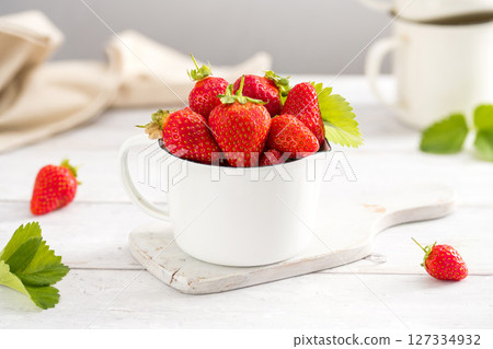 Fresh strawberries in a bowl, summer fruits. Bright background. Fresh strawberries in a bowl, summer fruits. Bright background. 127334932