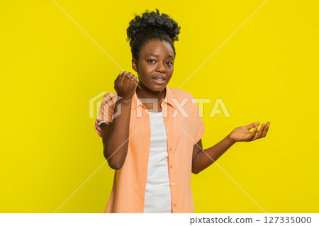 Confused Black woman knocking door gesture asking who is at home, feeling embarrassed, no idea Confused Black woman knocking door gesture asking who is at home, feeling embarrassed, no idea 127335000