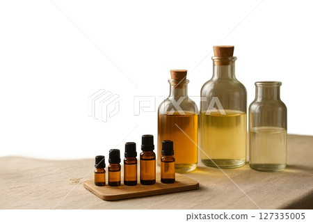 Various essential oil bottles arranged on a wooden surface in a serene setting showcasing natural wellness products Various essential oil bottles arranged on a wooden surface in a serene setting showcasing natural wellness products 127335005