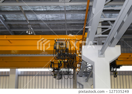 Overhead crane or lifting equipment inside factory or warehouse. 127335249