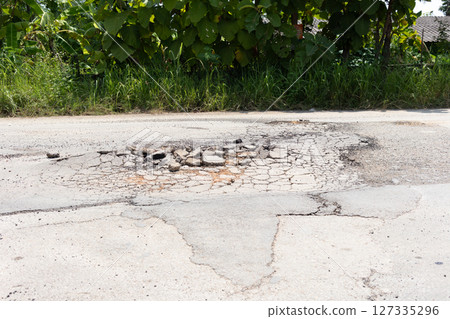 Asphalt road surface crack or damage. Asphalt road surface crack or damage. 127335296