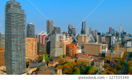 Dramatic toronto skyline revealing modern skyscrapers rising above business district during bright sunny day with expansive clear blue sky panorama. Urban style concept Canada 127335340