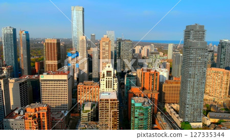 Toronto city skyline is displaying a mix of modern glass skyscrapers and traditional brick buildings, showcasing the city's architectural diversity and urban development. Urban style concept USA 127335344