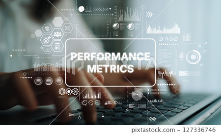 Hands Typing on Laptop Amidst Performance Metrics and Data Visualization Graphics in Modern Workspace Environment. Asymptotic smart data analytic 127336746