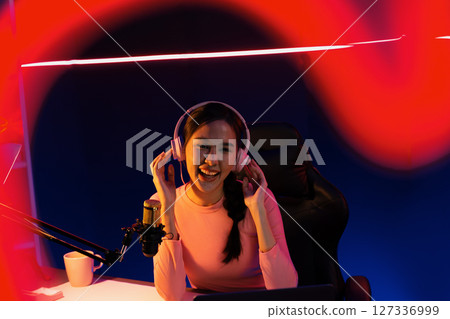 Smiling Asian influencer talking podcast with positive in red frame. Stratagem. Smiling Asian influencer talking podcast with positive in red frame. Stratagem. 127336999