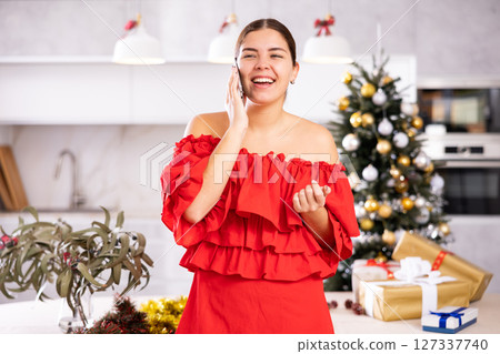 Talking on phone, girl shares plans for New Year Talking on phone, girl shares plans for New Year 127337740