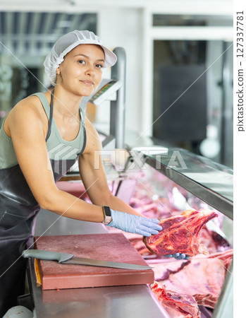 woman behind counter showcases 127337781