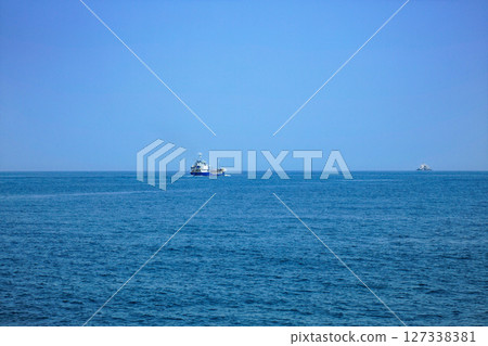 Open sea, cargo ship and Kurarase Lighthouse, from passenger ship Shiokaze 127338381