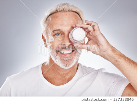 Portrait, senior man and cream for skincare, beauty and cosmetics on grey studio background. Face, mature male and elderly guy with lotion, serum and wellness for treatment, smooth skin and luxury Portrait, senior man and cream for skincare, beauty and cosmetics on grey studio background. Face, mature male and elderly guy with lotion, serum and wellness for treatment, smooth skin and luxury 127338846
