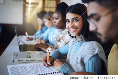 College student writing notes for business management in classroom, course and campus. Portrait, young indian girl and university student happy for learning, education and studying at finance academy 127338847