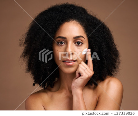 Skincare, cream and black woman in portrait for facial, beauty and cosmetics promotion of product in studio. African model with skin care, dermatology or sunscreen application on face 127339026
