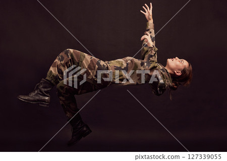 Anxiety, soldier and woman in studio for war ptsd, nightmare and horror, mental health and depression on black background. Military, flashback and girl in army crisis, trauma and fall Ukraine veteran 127339055