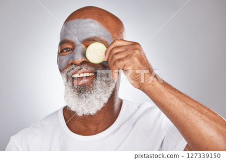 Skincare, face mask or happy old man with cucumber marketing or advertising natural vegan diet for glowing skin. Cream, portrait, senior black man with beauty or healthy anti aging facial cosmetics 127339150