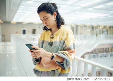 Woman typing, smartphone and connection for social media, conversation and search internet. Canada, female student or girl with cellphone, online reading and scroll for website, email or casual style 127339187