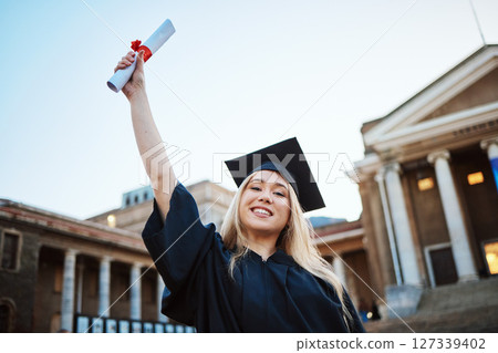 Education, graduation and portrait of woman at university, college and academic campus with diploma certificate. Celebration, graduate ceremony and girl student with success, victory and achievement 127339402
