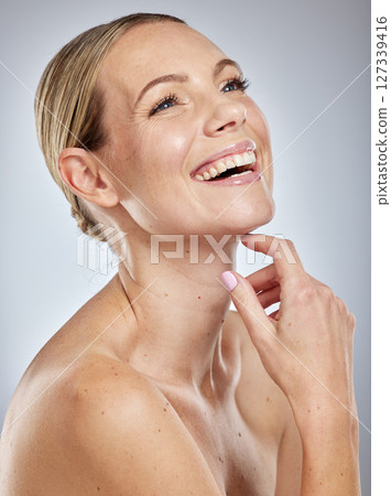 Beauty, skin and skincare with woman and happy with cosmetic treatment, glow and shine against studio background. Makeup, natural cosmetics and facial, face and body care with wellness and fresh. Beauty, skin and skincare with woman and happy with cosmetic treatment, glow and shine against studio background. Makeup, natural cosmetics and facial, face and body care with wellness and fresh. 127339416