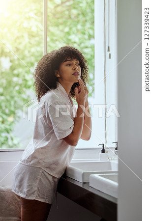 Black woman, acne pimple and morning in bathroom for start, skincare and face beauty in house. Gen z woman, facial skin health and hands for zit, dermatology and cosmetic self care at home in Atlanta Black woman, acne pimple and morning in bathroom for start, skincare and face beauty in house. Gen z woman, facial skin health and hands for zit, dermatology and cosmetic self care at home in Atlanta 127339423
