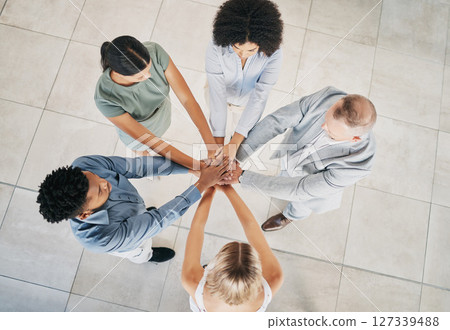 Office, business people and top view of a stack of hands for celebration, motivation or team building. Collaboration, diversity and overhead of a corporate team cheering for teamwork in the workplace 127339488
