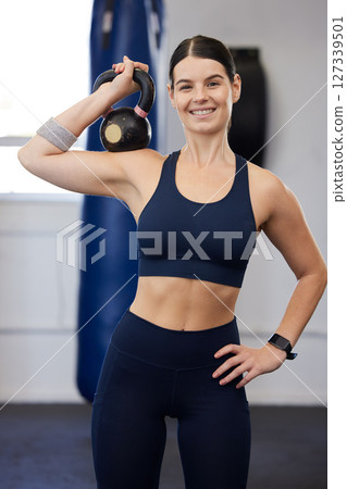Fitness, kettlebell and woman in gym with exercise portrait, strong and weightlifting and body builder. Body workout, training and body building with muscle and happy athlete, sports motivation. 127339501