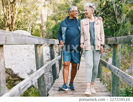 Relax, senior or couple of friends hiking, walking or trekking for freedom, exercise or fitness in nature forest. Interracial, travel or happy woman enjoys bonding time with healthy elderly partner Relax, senior or couple of friends hiking, walking or trekking for freedom, exercise or fitness in nature forest. Interracial, travel or happy woman enjoys bonding time with healthy elderly partner 127339520