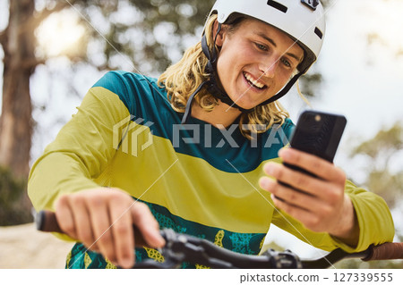 Social media, gps and man on a bike in nature, fitness cycling and search for location on a phone in the mountains of Indonesia. Contact, communication and person with a mobile on a bicycle in a park 127339555