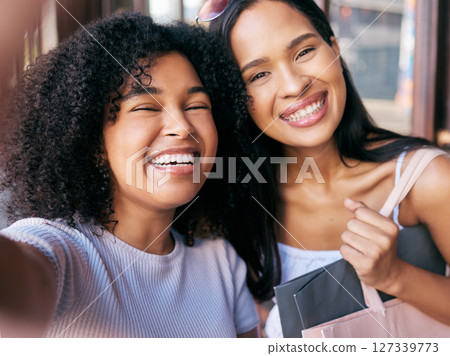 Friends, selfie and shopping date with black women, smile and happiness together with retail, sale and discount at shopping mall. Portrait, happy in photograph and freedom, customer and shop outdoor Friends, selfie and shopping date with black women, smile and happiness together with retail, sale and discount at shopping mall. Portrait, happy in photograph and freedom, customer and shop outdoor 127339773
