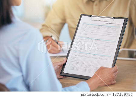 Medical documents, patient with clipboard and health with insurance and contract, healthcare paperwork with hands and checklist. Health insurance, reading document for health care and personal data. 127339795