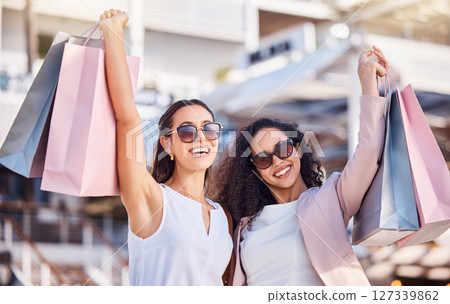 Women, shopping and friends in city, bags or sale products for luxury boutique or purchase fashion. Females, girls or customers spending money, retail for spree or expensive clothes for clients 127339862