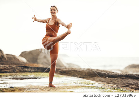 Exercise, woman and stretching on beach, workout and fitness for balance, wellness and health. Female, girl and training on seaside, zen and practice for performance, healthy and energy for power. 127339969