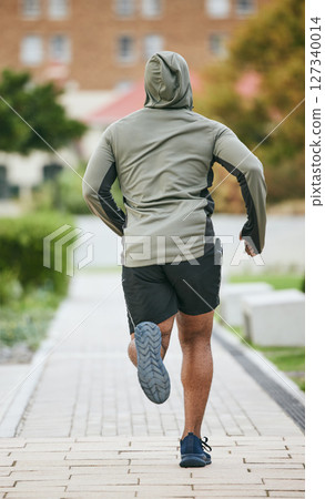 Fitness, back and black man running in city in winter for health, wellness and strength. Sports, exercise and male runner training, cardio jog or exercising outdoors alone on street for marathon. Fitness, back and black man running in city in winter for health, wellness and strength. Sports, exercise and male runner training, cardio jog or exercising outdoors alone on street for marathon. 127340014