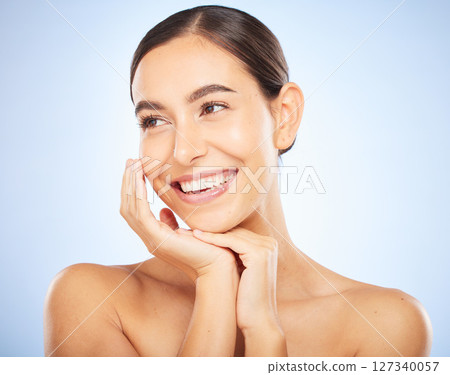 Woman, face and happy thinking of beauty, skincare wellness or luxury salon spa dermatology in blue background. Facial care vision, happiness and model smile with cosmetics glowing skin in studio 127340057