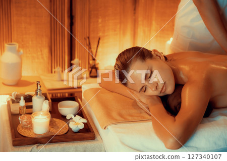 Caucasian woman customer enjoying relaxing anti-stress massage. Quiescent 127340107